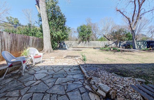 view of patio with an outbuilding, a fenced backyard, and a shed