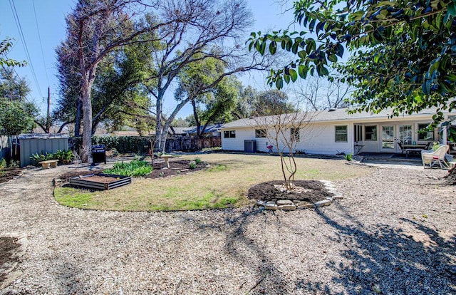 view of yard featuring a patio, french doors, and fence