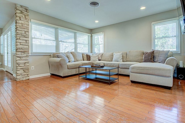 living room with wood-type flooring, visible vents, baseboards, and recessed lighting