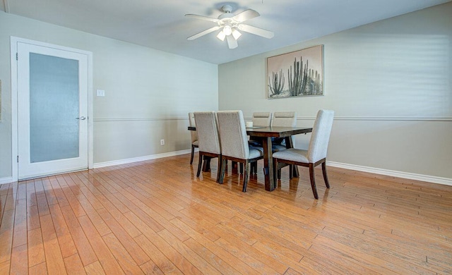 dining space featuring light wood-style floors, ceiling fan, and baseboards