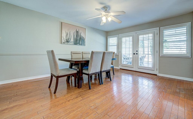 dining area featuring baseboards, french doors, a ceiling fan, and light wood-style floors