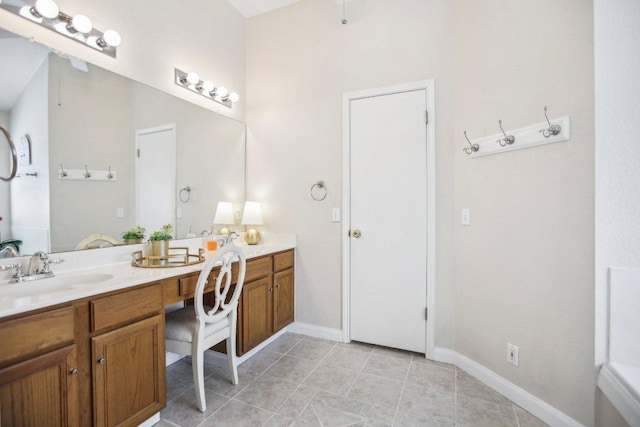 16710 Sabertooth Dr, Round Rock, TX 78681 - full bathroom with double vanity, baseboards, and tile patterned floors