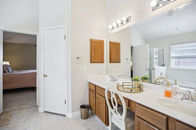 16710 Sabertooth Dr, Round Rock, TX 78681 - full bath featuring double vanity, connected bathroom, a bath, a ceiling fan, and tile patterned floors