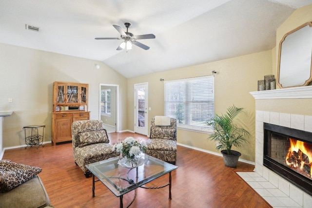 16710 Sabertooth Dr, Round Rock, TX 78681 - living area with lofted ceiling, a tile fireplace, a ceiling fan, wood finished floors, and baseboards