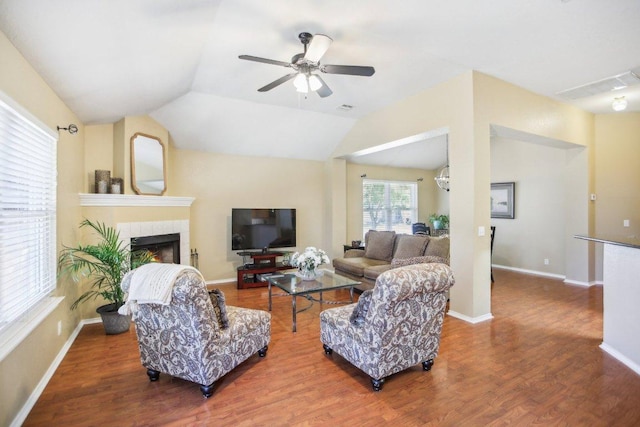 16710 Sabertooth Dr, Round Rock, TX 78681 - living area featuring wood finished floors, a ceiling fan, a fireplace, lofted ceiling, and baseboards