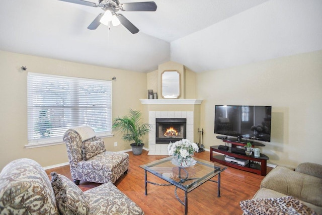 16710 Sabertooth Dr, Round Rock, TX 78681 - living area featuring lofted ceiling, a tile fireplace, wood finished floors, a ceiling fan, and baseboards