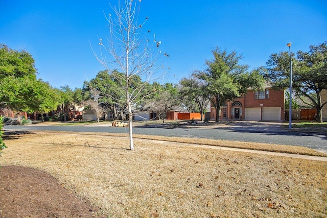 16710 Sabertooth Dr, Round Rock, TX 78681 - view of yard featuring an attached garage and driveway