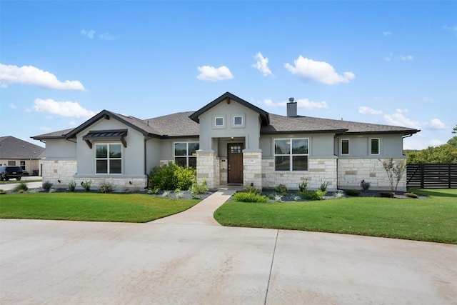 view of front of home with fence, a chimney, a front lawn, and stucco siding