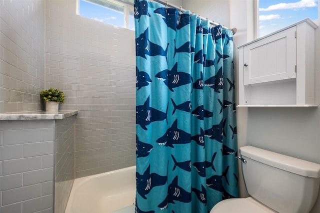 full bathroom featuring shower / tub combo and toilet