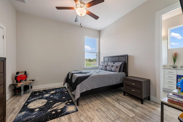 bedroom with light wood finished floors, a ceiling fan, and baseboards