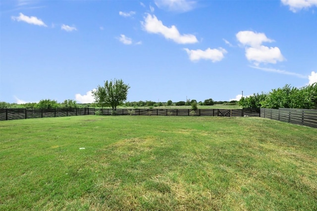 view of yard with a rural view and fence