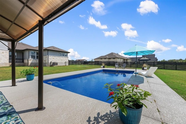 view of pool with a yard, a patio, a fenced backyard, and a fenced in pool