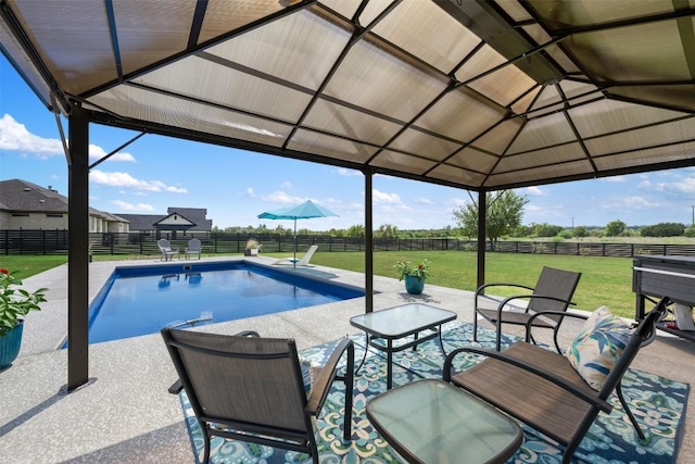 view of swimming pool with a fenced backyard, a fenced in pool, a lawn, and a patio