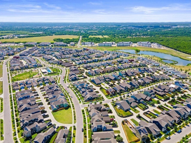 drone / aerial view with a water view and a residential view