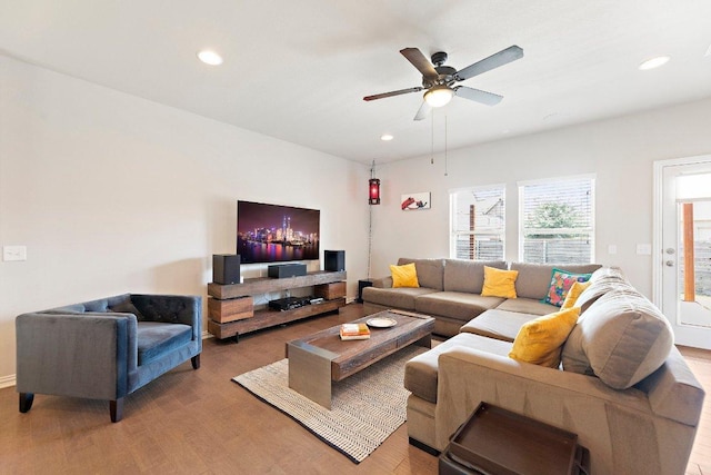 living area with light wood-type flooring, ceiling fan, and recessed lighting