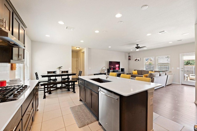 kitchen with stainless steel appliances, light countertops, visible vents, and a sink