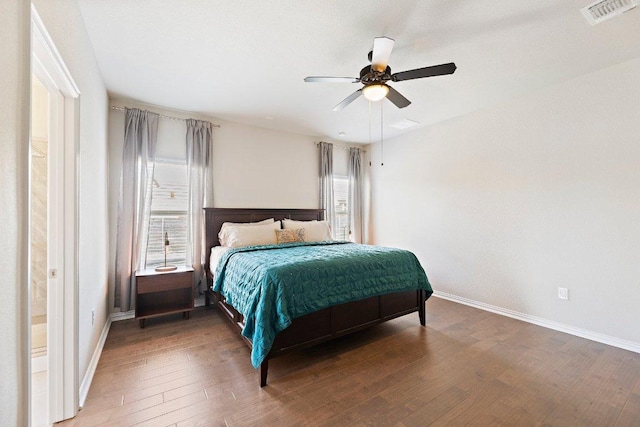 bedroom featuring a ceiling fan, wood-type flooring, visible vents, and baseboards