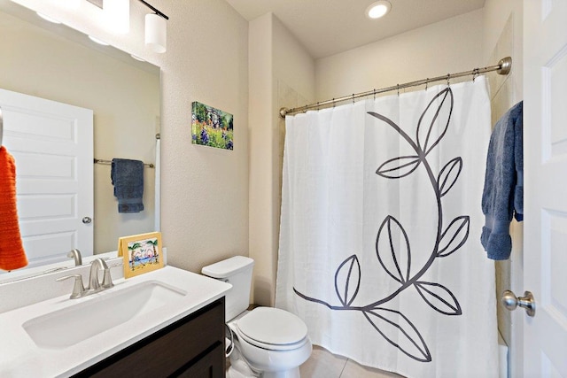 bathroom with curtained shower, vanity, toilet, and tile patterned floors