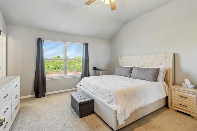 bedroom featuring light carpet, ceiling fan, baseboards, and vaulted ceiling