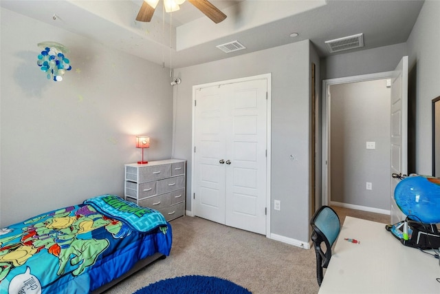 carpeted bedroom featuring a ceiling fan, a closet, visible vents, and baseboards