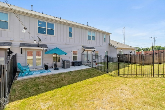 back of property featuring a patio, central AC, fence, a lawn, and board and batten siding