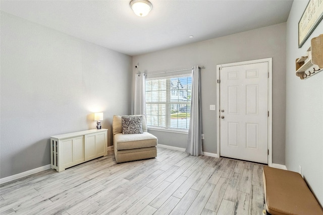 living area featuring light wood-style floors and baseboards