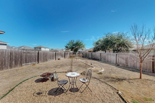 view of yard with an outdoor fire pit and a fenced backyard