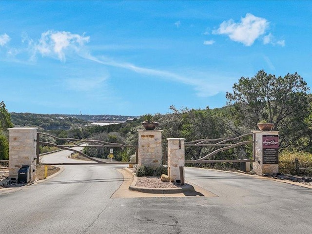 view of road featuring a gate and a gated entry