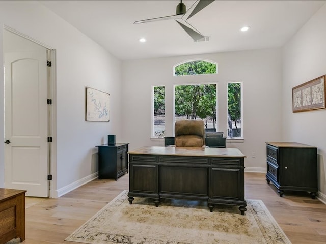 office featuring ceiling fan, light wood finished floors, and baseboards