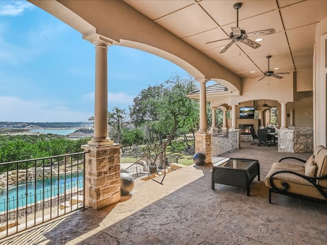 view of patio with ceiling fan and a fenced in pool