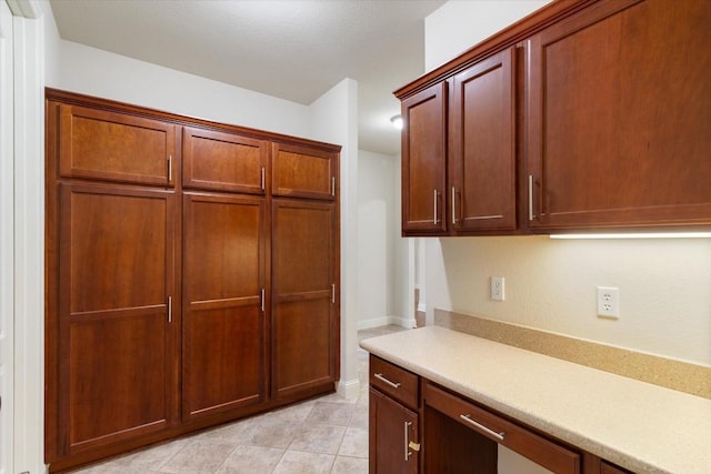 kitchen with light tile patterned floors and light countertops