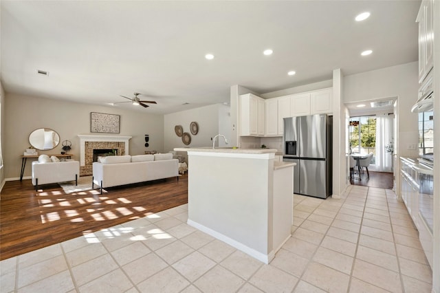 kitchen with a fireplace, recessed lighting, light countertops, visible vents, and appliances with stainless steel finishes