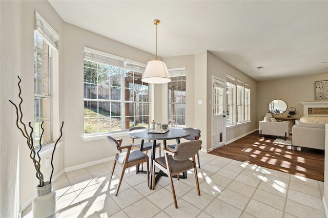 dining space featuring light tile patterned flooring, visible vents, and baseboards