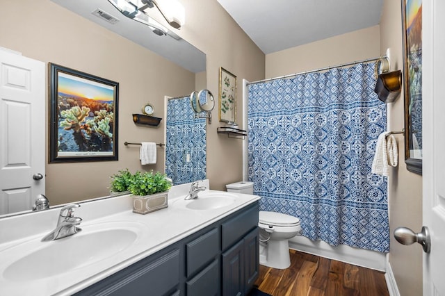 5312 Fort Benton Dr, Austin, TX 78735 - bathroom featuring toilet, wood finished floors, and double vanity