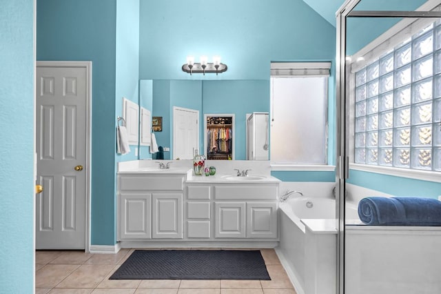 5312 Fort Benton Dr, Austin, TX 78735 - bathroom with tile patterned floors, healthy amount of natural light, double vanity, and vaulted ceiling