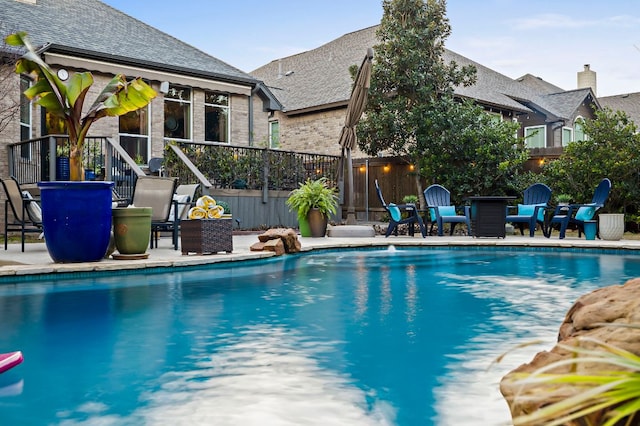 view of pool with a fenced in pool, a patio, and fence