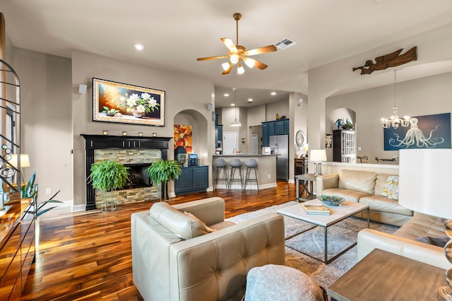 5312 Fort Benton Dr, Austin, TX 78735 - living area with arched walkways, dark wood finished floors, a ceiling fan, a chandelier, and baseboards