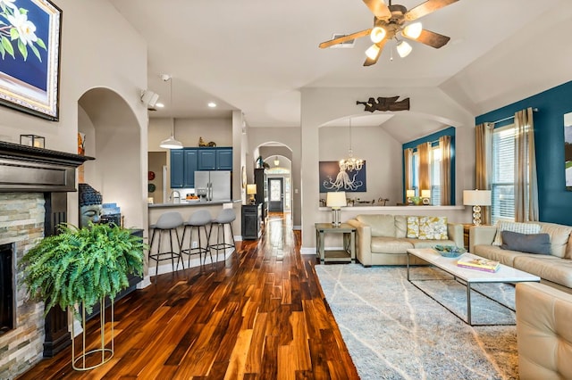 5312 Fort Benton Dr, Austin, TX 78735 - living area with arched walkways, a ceiling fan, dark wood-type flooring, a chandelier, and a fireplace
