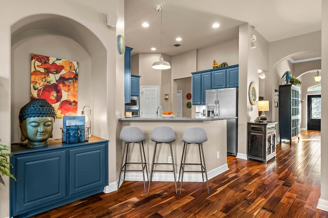 5312 Fort Benton Dr, Austin, TX 78735 - kitchen with appliances with stainless steel finishes, blue cabinets, dark wood-type flooring, a peninsula, and recessed lighting