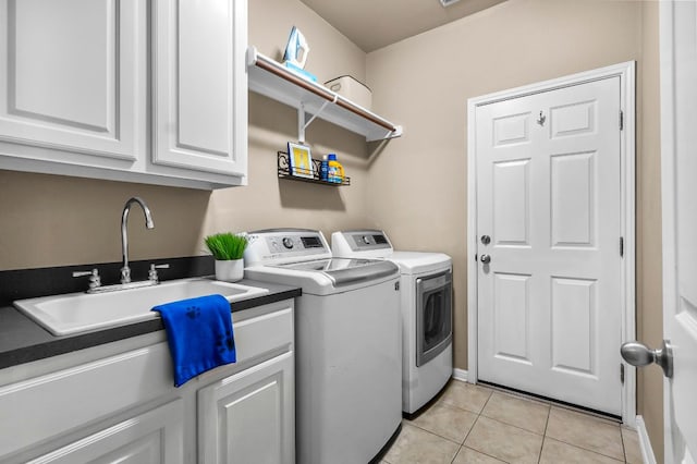 5312 Fort Benton Dr, Austin, TX 78735 - washroom featuring independent washer and dryer, light tile patterned floors, cabinet space, and baseboards