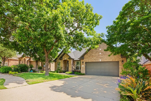 5312 Fort Benton Dr, Austin, TX 78735 - view of front of home with an attached garage, driveway, brick siding, and a front yard