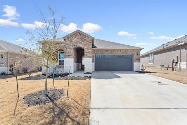 view of front facade featuring a garage, concrete driveway, roof with shingles, a front lawn, and brick siding