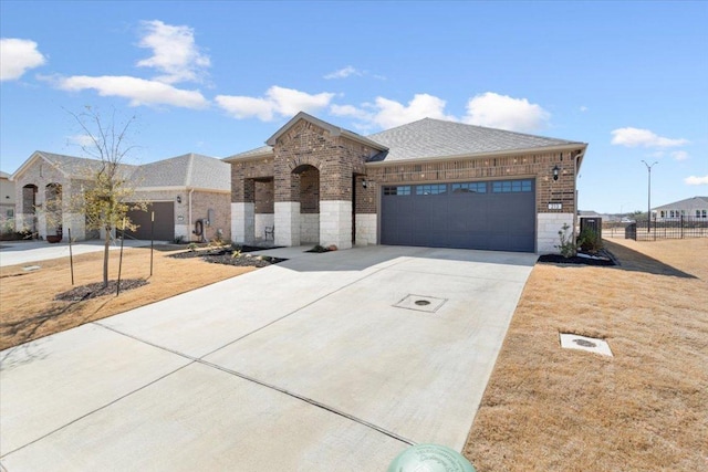 view of front of house with concrete driveway, brick siding, an attached garage, and roof with shingles