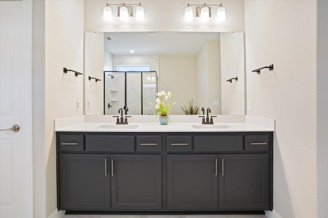 full bathroom featuring a sink, a shower stall, baseboards, and double vanity