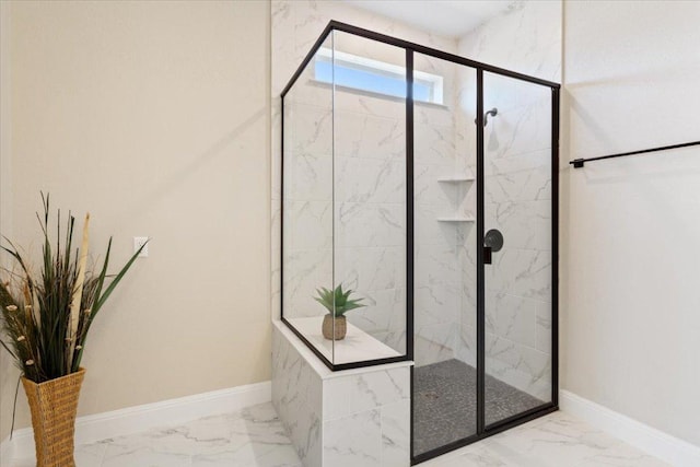 full bathroom featuring marble finish floor, a marble finish shower, and baseboards