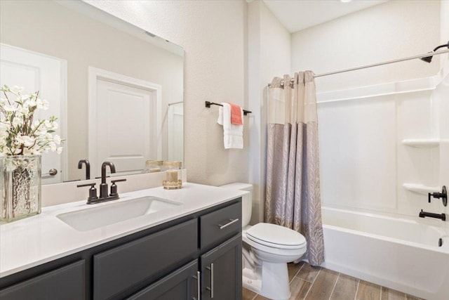 full bath with toilet, shower / tub combo, vanity, and wood finish floors