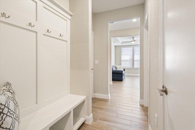 mudroom with wood tiled floor, baseboards, and ceiling fan