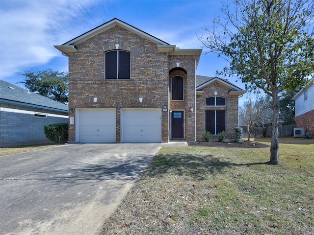 view of front of home with brick siding, a front lawn, fence, a garage, and driveway