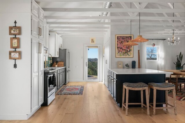 200 Hilltop Dr, Dripping Springs, TX 78620 - kitchen featuring stainless steel appliances, a kitchen breakfast bar, white cabinetry, beam ceiling, and light countertops