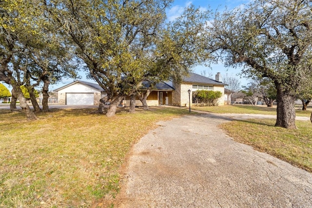 ranch-style house featuring a garage, driveway, and a front yard